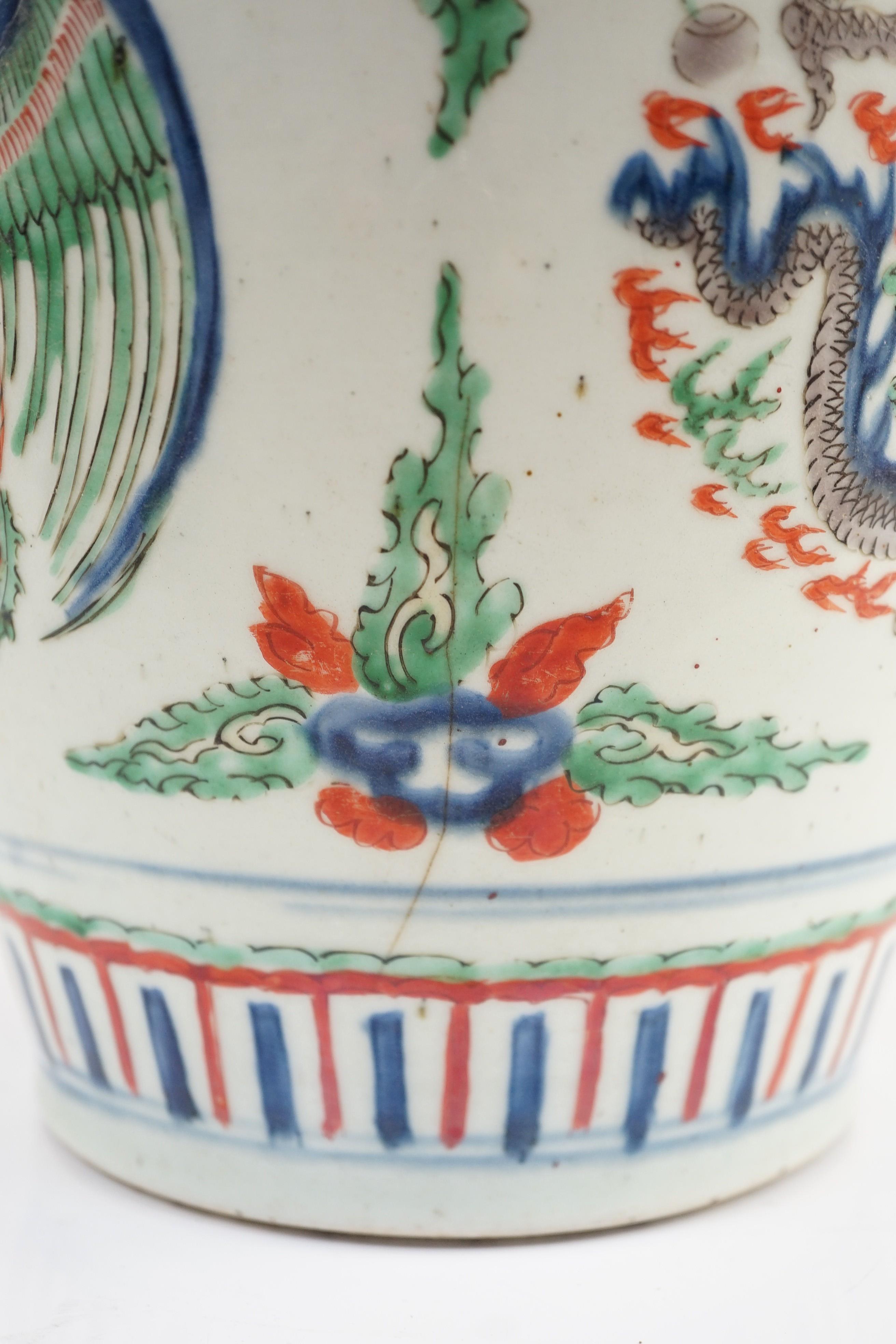 A Chinese Transitional wucai ‘dragon and phoenix roundel’ vase, 17th century, 30cm high, cracks